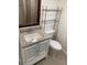 Bathroom with granite vanity, modern fixtures, and storage rack at 320 N Bayshore Blvd # 203, Clearwater, FL 33759