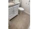 Bathroom featuring a granite-top vanity and a modern white toilet at 320 N Bayshore Blvd # 203, Clearwater, FL 33759