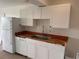 Bright kitchen features white cabinets, wood countertops, stainless steel sink and appliances at 320 N Bayshore Blvd # 203, Clearwater, FL 33759