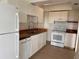 Modern kitchen boasts white cabinets, stainless steel sink, and matching appliances at 320 N Bayshore Blvd # 203, Clearwater, FL 33759