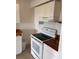 Functional kitchen features white appliances and beautiful butcher block countertops at 320 N Bayshore Blvd # 203, Clearwater, FL 33759