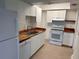 Bright kitchen features white cabinets, wood countertops, stainless steel sink and appliances at 320 N Bayshore Blvd # 203, Clearwater, FL 33759
