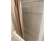 Clean shower features white tile, a convenient shower niche, and neutral shower curtain at 320 N Bayshore Blvd # 203, Clearwater, FL 33759