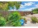 Landscaped backyard with a wooden fence, trees, and lounge chairs at 3743 Cherrywood Dr, Holiday, FL 34691