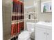 Cozy bathroom featuring a shower with designer curtain, toilet, and modern vanity at 3743 Cherrywood Dr, Holiday, FL 34691