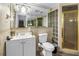 Bathroom features tile walls, a shower, and a mirrored wall at 3743 Cherrywood Dr, Holiday, FL 34691