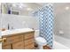 Cozy bathroom with a wood vanity and a shower/tub combo at 3743 Cherrywood Dr, Holiday, FL 34691