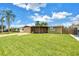 Beautiful single-story house featuring a screened patio and well-kept lawn at 3743 Cherrywood Dr, Holiday, FL 34691