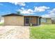 Inviting single-story home with a screened porch and lush green lawn at 3743 Cherrywood Dr, Holiday, FL 34691