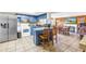 Cozy kitchen featuring blue cabinets, a breakfast bar, and dining area with view of the backyard at 3743 Cherrywood Dr, Holiday, FL 34691