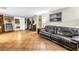 The living room has terracotta tile, a black sofa, and an arcade game room at 3743 Cherrywood Dr, Holiday, FL 34691