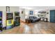 Spacious living room with terracotta tile, black leather sofa, and arcade games at 3743 Cherrywood Dr, Holiday, FL 34691