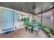 Charming patio area with seating, plants, and unique light fixture at 3743 Cherrywood Dr, Holiday, FL 34691