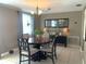 Bright dining room with a round table set, chandelier, and neutral color palette at 3811 Elmwood Dr, Holiday, FL 34691