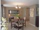 Bright dining room with a round table set, chandelier, and neutral color palette at 3811 Elmwood Dr, Holiday, FL 34691