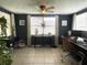 Office space with neutral tile floor, ceiling fan, and large window offering natural light at 3811 Elmwood Dr, Holiday, FL 34691