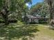 Charming home beneath mature trees with Spanish moss creating a picturesque and inviting curb appeal at 4205 Old Mulberry Rd, Plant City, FL 33567