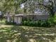Charming single-story home featuring a cozy front porch and lush, mature landscaping at 4205 Old Mulberry Rd, Plant City, FL 33567