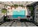 An aerial view shows a clear blue pool surrounded by lounge chairs and lush landscaping in a courtyard at 4221 W Spruce St # 2328, Tampa, FL 33607