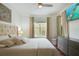 Cozy bedroom with a large window, neutral tones, and a wall-mounted television at 4221 W Spruce St # 2328, Tampa, FL 33607