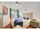 Bright bedroom with hardwood floors, a ceiling fan, and natural light from the window at 4221 W Spruce St # 2328, Tampa, FL 33607
