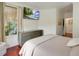 Inviting bedroom featuring a mounted TV, dresser, and bright window, offering a relaxing ambiance at 4221 W Spruce St # 2328, Tampa, FL 33607