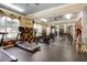 The gym features treadmills, weights, exercise equipment, and natural light from several windows at 4221 W Spruce St # 2328, Tampa, FL 33607