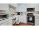 Modern kitchen featuring stainless steel appliances, white cabinets, and marble countertops at 4221 W Spruce St # 2328, Tampa, FL 33607