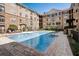 A clear blue pool is surrounded by lounge chairs and lush landscaping in a courtyard setting at 4221 W Spruce St # 2328, Tampa, FL 33607