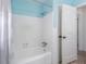Bright tub/shower in bathroom features bright paint, white tiles, and shower curtain at 429 87Th Ave, St Pete Beach, FL 33706