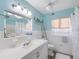 Bright bathroom has a large mirror, white tile, and nautical decorations at 429 87Th Ave, St Pete Beach, FL 33706