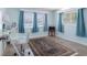 Bedroom with large rug under desk and three windows with blinds and curtains at 429 87Th Ave, St Pete Beach, FL 33706