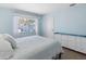 Comfortable bedroom has bright walls, a large window with curtains, and a dresser at 429 87Th Ave, St Pete Beach, FL 33706