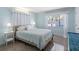 Bright bedroom with neutral walls and light-colored carpet features a large window with curtains at 429 87Th Ave, St Pete Beach, FL 33706