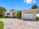 Charming single-story home with a well-maintained lawn, attached garage and inviting front entrance at 429 87Th Ave, St Pete Beach, FL 33706
