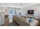 Bright living room features a comfortable sectional, modern furniture, and direct access to the backyard pool area at 429 87Th Ave, St Pete Beach, FL 33706