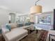 Bright living room with a large sectional, stylish decor, and seamless indoor-outdoor flow to the pool area at 429 87Th Ave, St Pete Beach, FL 33706