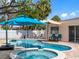 Inviting backyard pool and spa area, perfect for relaxation and entertaining, with nearby patio seating at 429 87Th Ave, St Pete Beach, FL 33706
