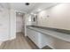 Bathroom featuring a long vanity with a gray countertop and white cabinetry at 450 Treasure Isle Causeway # 212, Treasure Island, FL 33706