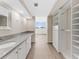 Bathroom showcasing a long vanity, framed mirrors, and view to bedroom and walk-in closet at 450 Treasure Isle Causeway # 212, Treasure Island, FL 33706