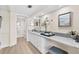 Bathroom featuring a long vanity with a gray countertop, white cabinetry, and modern fixtures at 450 Treasure Isle Causeway # 212, Treasure Island, FL 33706