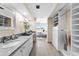 Bathroom showcasing a long vanity, framed mirrors, and walk-in closet at 450 Treasure Isle Causeway # 212, Treasure Island, FL 33706