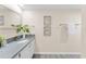 Bathroom featuring a vanity with a gray countertop, white cabinetry, and artwork at 450 Treasure Isle Causeway # 212, Treasure Island, FL 33706