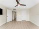 Well-lit bedroom featuring gray toned wood-look floors, a contemporary ceiling fan, and neutral wall color at 450 Treasure Isle Causeway # 212, Treasure Island, FL 33706