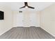 A well-lit bedroom with a contemporary ceiling fan, neutral wall color, and wood look floors at 450 Treasure Isle Causeway # 212, Treasure Island, FL 33706