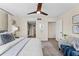 Bright bedroom featuring a ceiling fan, walk-in closet with ample storage, and seating area with modern decor at 450 Treasure Isle Causeway # 212, Treasure Island, FL 33706