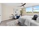 Brightly lit bedroom showcasing a ceiling fan, large windows, and tasteful decor with calming colors at 450 Treasure Isle Causeway # 212, Treasure Island, FL 33706