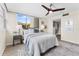 Airy bedroom showcasing a contemporary ceiling fan, natural light from the window, closet, and minimalist decor at 450 Treasure Isle Causeway # 212, Treasure Island, FL 33706