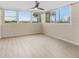 Empty room with ample light via large windows and view, ceiling fan, and neutral paint for personalization at 450 Treasure Isle Causeway # 212, Treasure Island, FL 33706