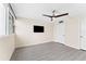 Bright bedroom with updated flooring, ceiling fan, and a mounted TV at 450 Treasure Isle Causeway # 212, Treasure Island, FL 33706